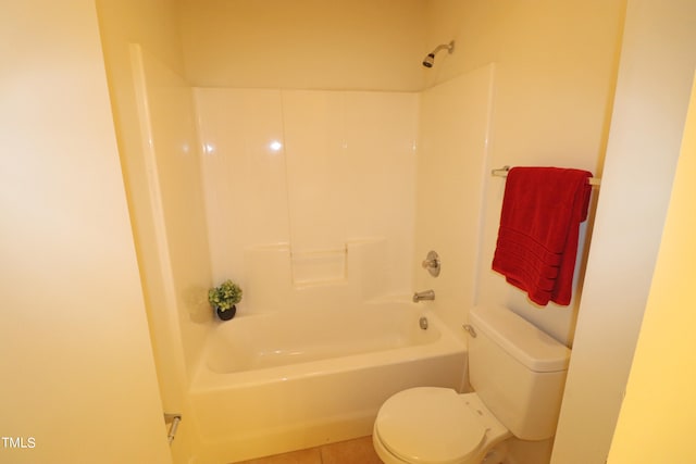 bathroom with tile patterned floors, bathing tub / shower combination, and toilet