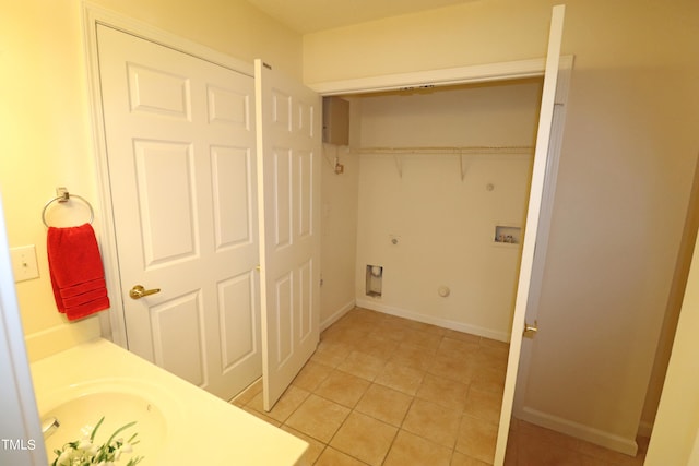 laundry area with hookup for a gas dryer, light tile patterned floors, washer hookup, and hookup for an electric dryer