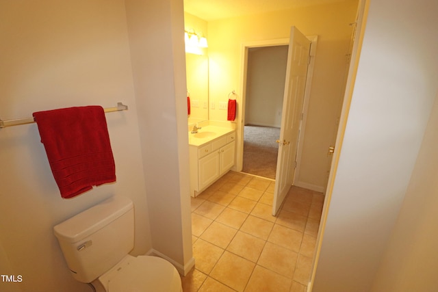 bathroom featuring tile patterned floors, vanity, and toilet