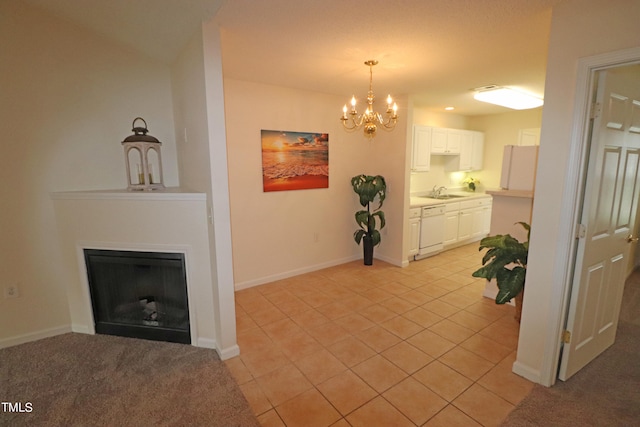 dining space with sink, light tile patterned flooring, and a notable chandelier