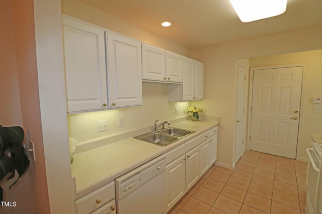 kitchen featuring white cabinetry, sink, light tile patterned floors, and white appliances