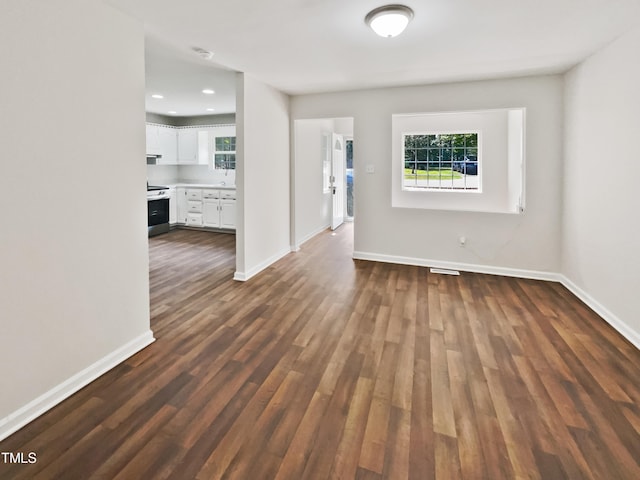 spare room with dark wood-type flooring