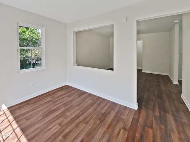 empty room featuring dark wood-type flooring