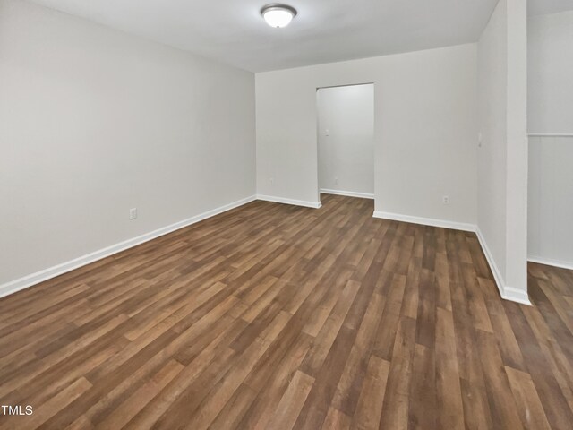 empty room with dark hardwood / wood-style flooring