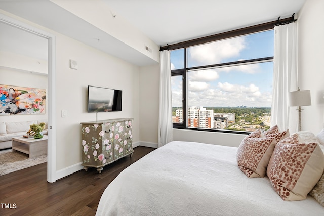 bedroom with dark hardwood / wood-style flooring