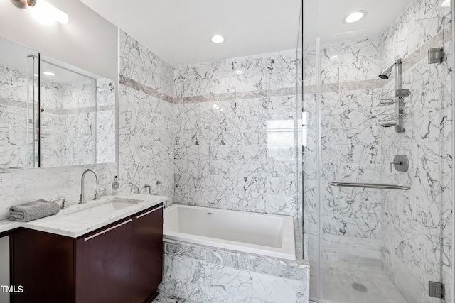 bathroom with plus walk in shower, tile walls, and vanity