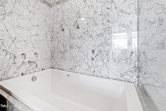 bathroom featuring a relaxing tiled tub