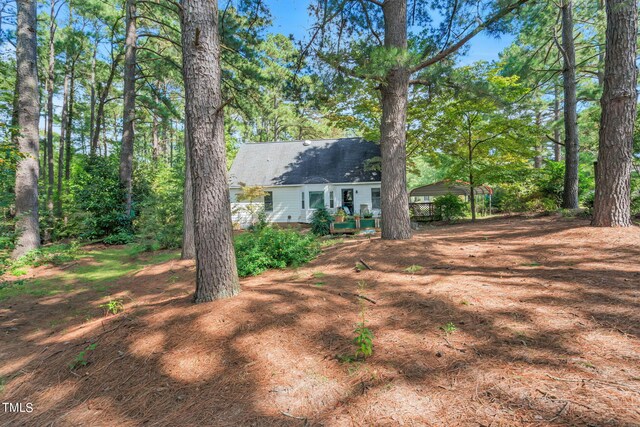 view of yard with a carport and a wooden deck