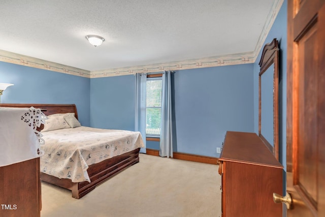 bedroom with a textured ceiling and light carpet