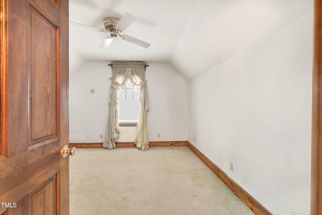 additional living space with ceiling fan, light carpet, and lofted ceiling