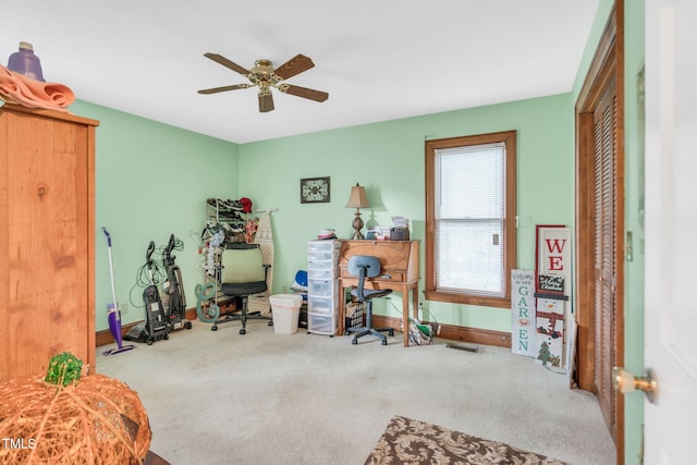 exercise area with light colored carpet and ceiling fan