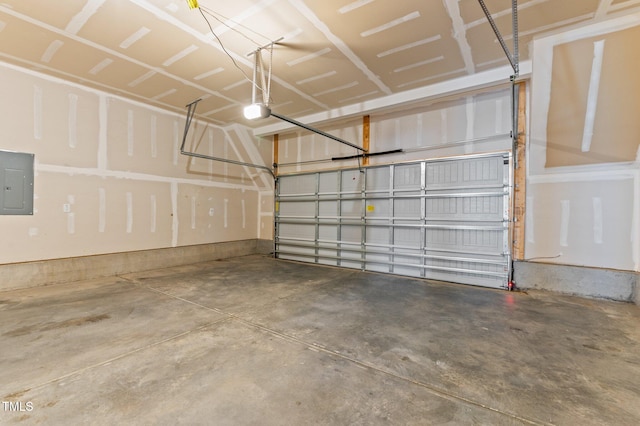 garage with a garage door opener and electric panel