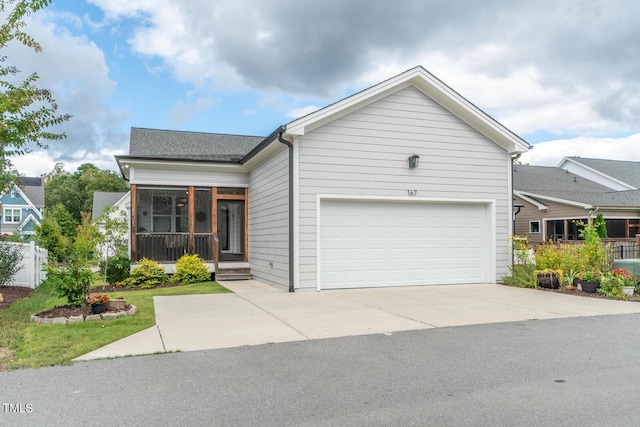 ranch-style home with concrete driveway and an attached garage