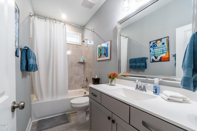 full bathroom featuring vanity, shower / bathtub combination with curtain, wood-type flooring, and toilet