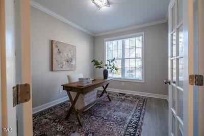 home office with crown molding, baseboards, and wood finished floors