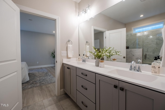 full bath with double vanity, ensuite bath, a shower stall, and a sink