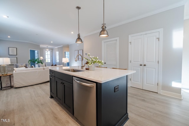 kitchen featuring a center island with sink, dishwasher, open floor plan, light countertops, and a sink