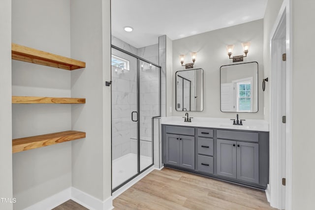 bathroom featuring vanity, a shower with shower door, and hardwood / wood-style flooring