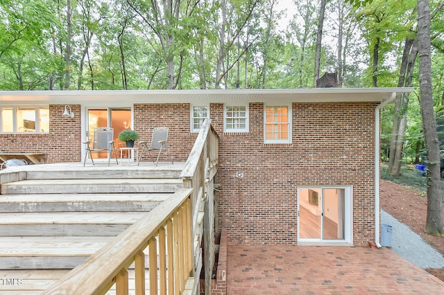 exterior space with brick siding and a chimney