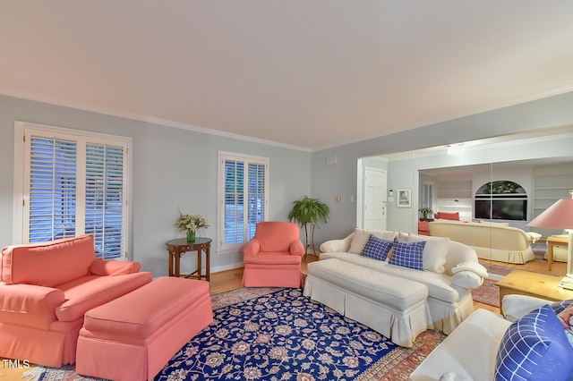 living area featuring ornamental molding, wood finished floors, and baseboards