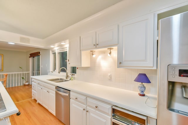 kitchen with white cabinetry, stainless steel appliances, and light countertops