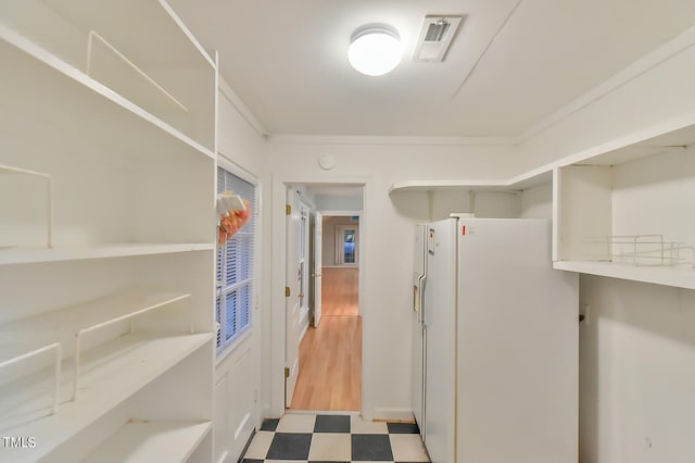 hall with visible vents and tile patterned floors