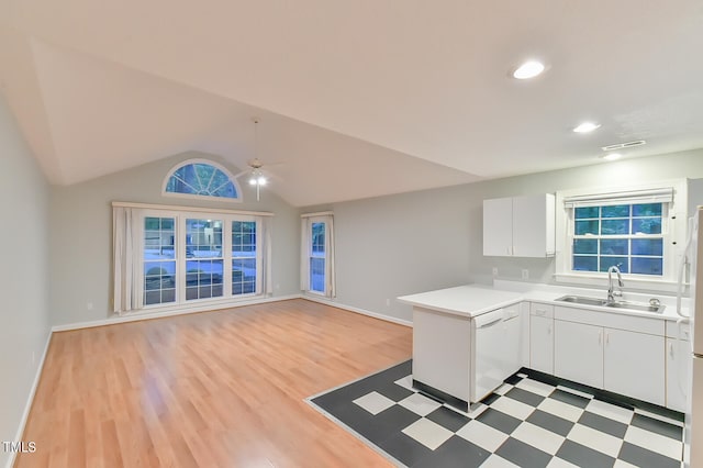 kitchen featuring light countertops, open floor plan, white cabinetry, a sink, and dishwasher