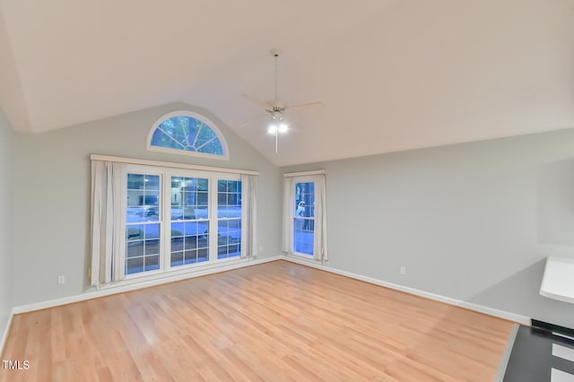 unfurnished living room with a ceiling fan, light wood-type flooring, lofted ceiling, and baseboards