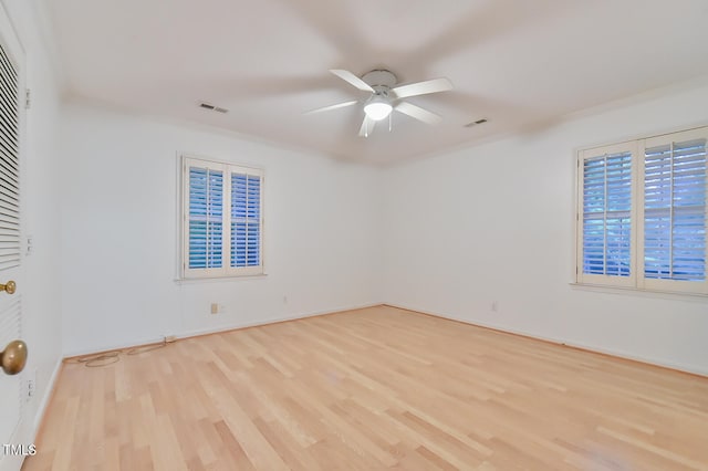 unfurnished room featuring a ceiling fan, visible vents, and light wood finished floors