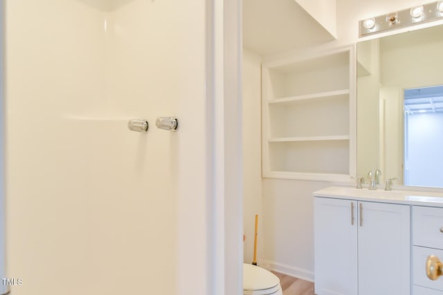 bathroom featuring toilet and vanity