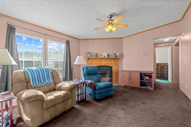 living area featuring ceiling fan, crown molding, a textured ceiling, and dark colored carpet