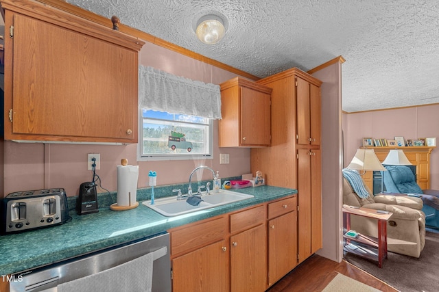 kitchen with a textured ceiling, dishwasher, crown molding, dark hardwood / wood-style flooring, and sink