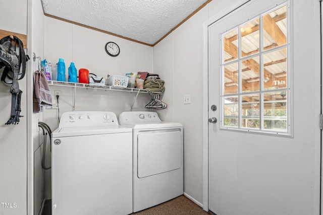 laundry area featuring ornamental molding, a textured ceiling, and separate washer and dryer
