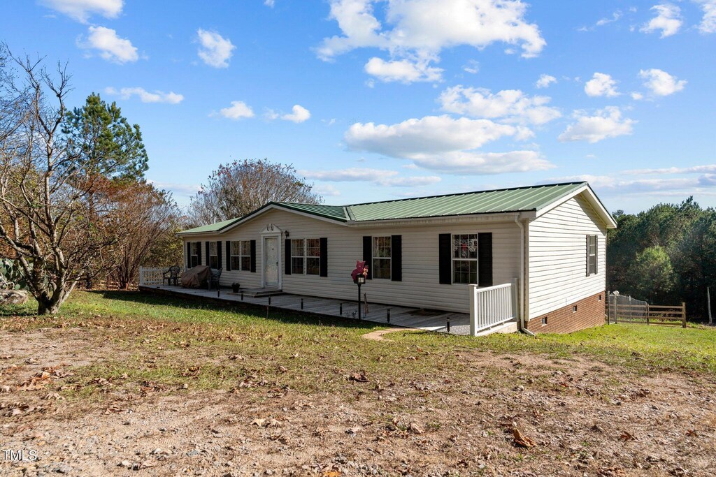 754 Firestone Ln, Sanford, NC 27330 - view of front facade with a patio area and a front yard
