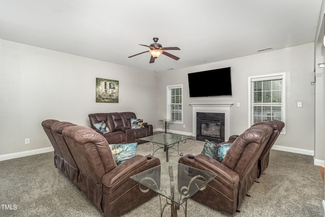 carpeted living room with ceiling fan and a wealth of natural light