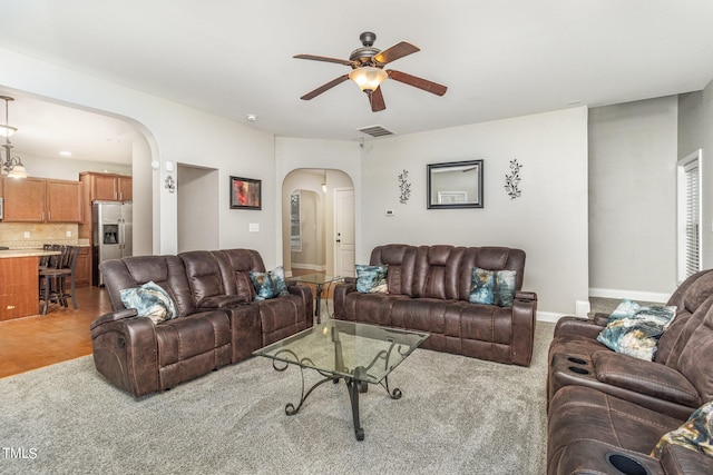 living room featuring ceiling fan and light carpet