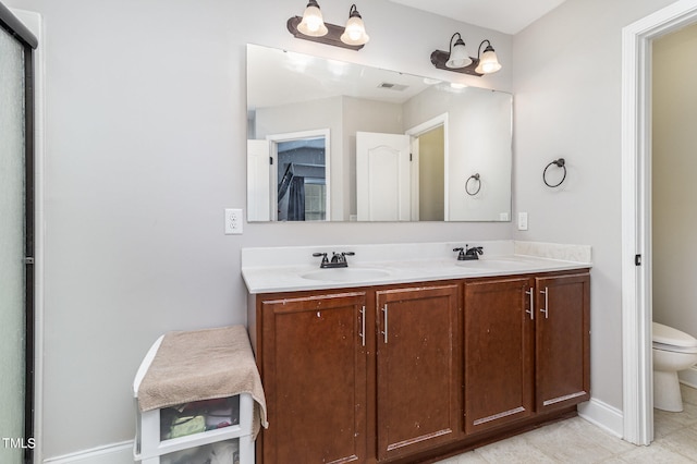 bathroom with tile patterned floors, vanity, and toilet