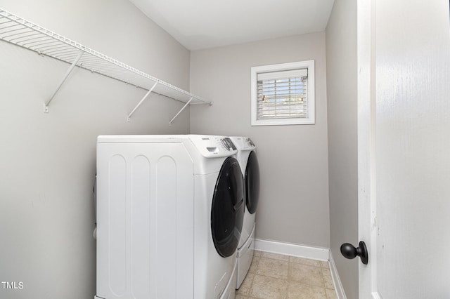 laundry area featuring light tile patterned floors and separate washer and dryer