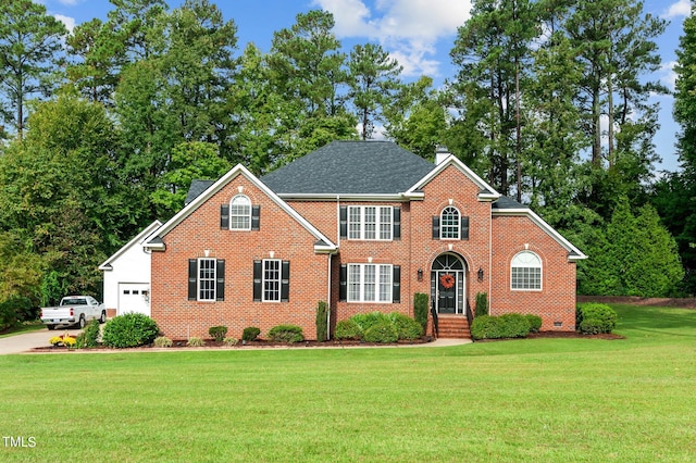 view of front facade featuring a front yard and a garage