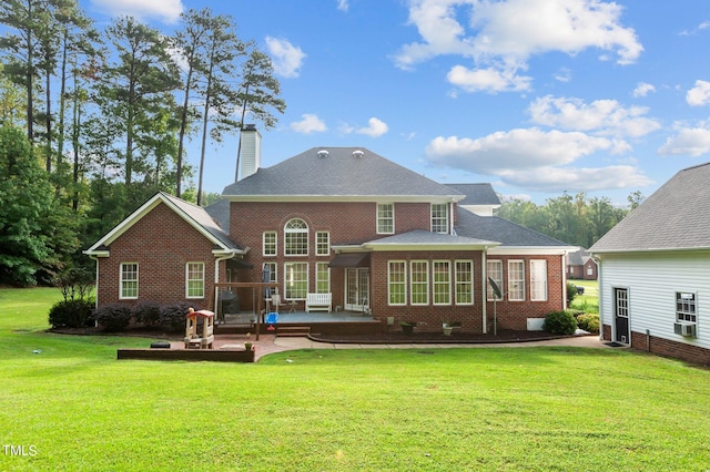 back of house featuring a lawn and a patio area