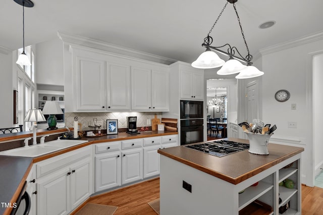 kitchen featuring white cabinets, light wood-type flooring, sink, and black appliances