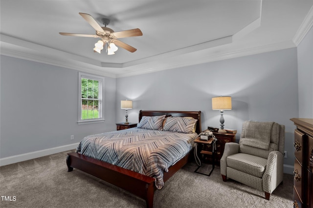 bedroom featuring ornamental molding, carpet, ceiling fan, and a raised ceiling