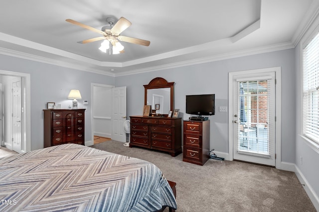 carpeted bedroom featuring access to outside, a tray ceiling, crown molding, and ceiling fan