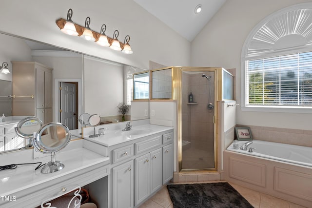 bathroom featuring tile patterned flooring, vaulted ceiling, vanity, and plus walk in shower