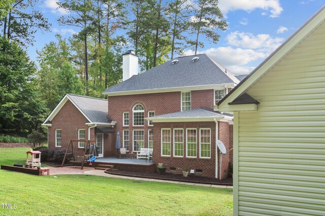 back of house with a yard and a patio area