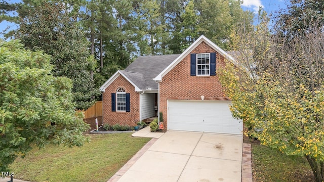 view of front of property featuring a front lawn and a garage