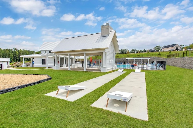 back of house featuring a patio area and a yard