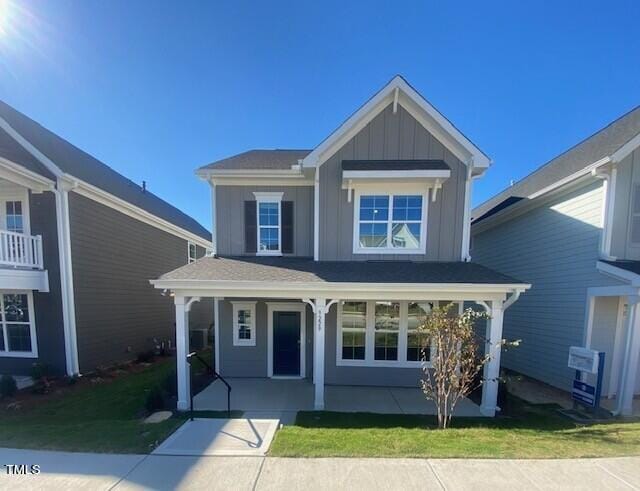 view of front of house with covered porch and a front yard