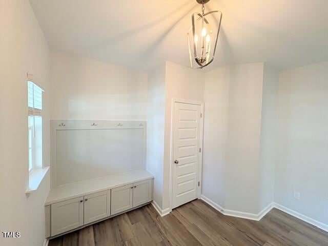 mudroom with hardwood / wood-style flooring and an inviting chandelier