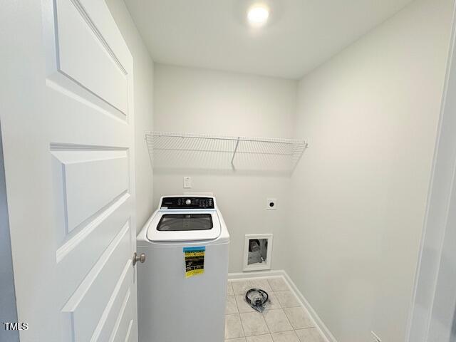 washroom featuring washer / clothes dryer and light tile patterned flooring